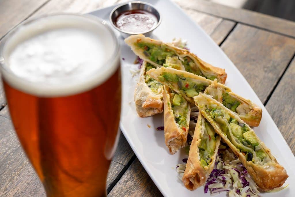 avocado egg rolls and beer on the patio